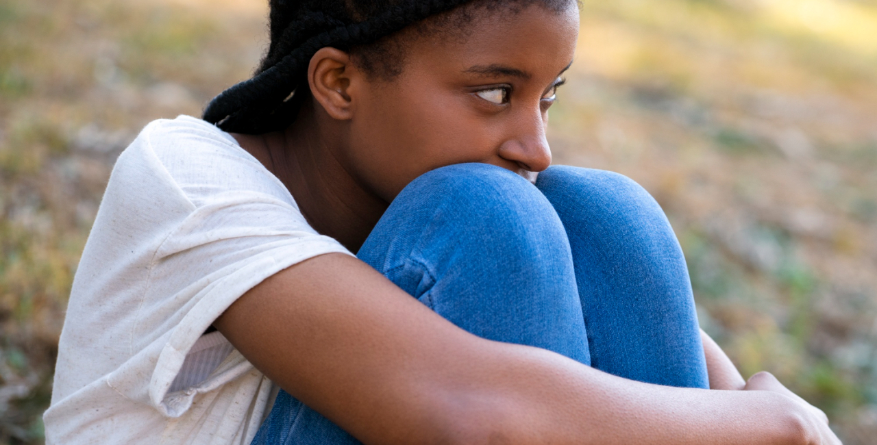 Child sitting and feeling sad